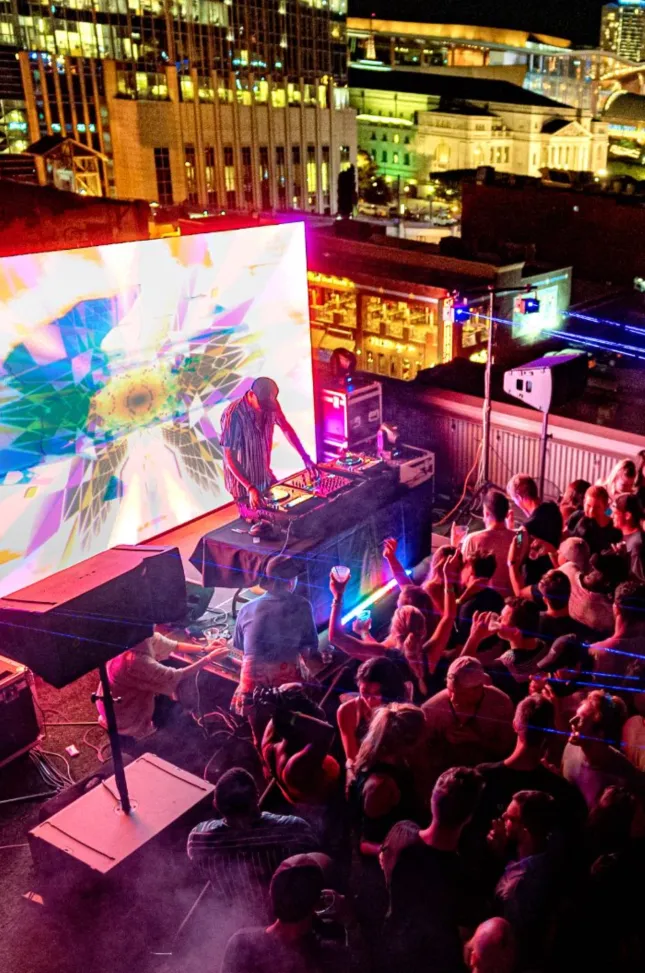 Audience watches a vivid LED stage presentation at a nighttime event