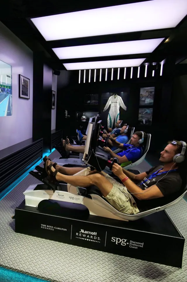 Guests race in simulators beneath the booth’s illuminated ceiling