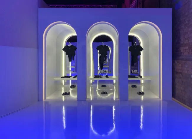 Nike apparel and shoes displayed in illuminated arched niches