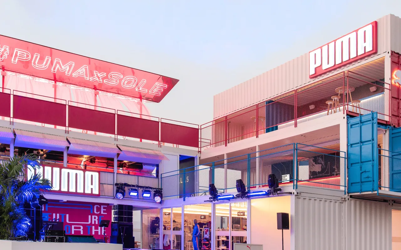 Two-story Puma pavilion with terraces and exterior stage lighting