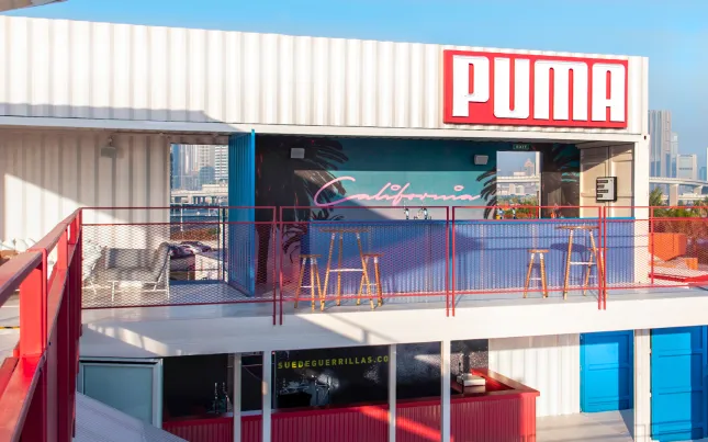 Puma storefront and terrace built from white shipping containers