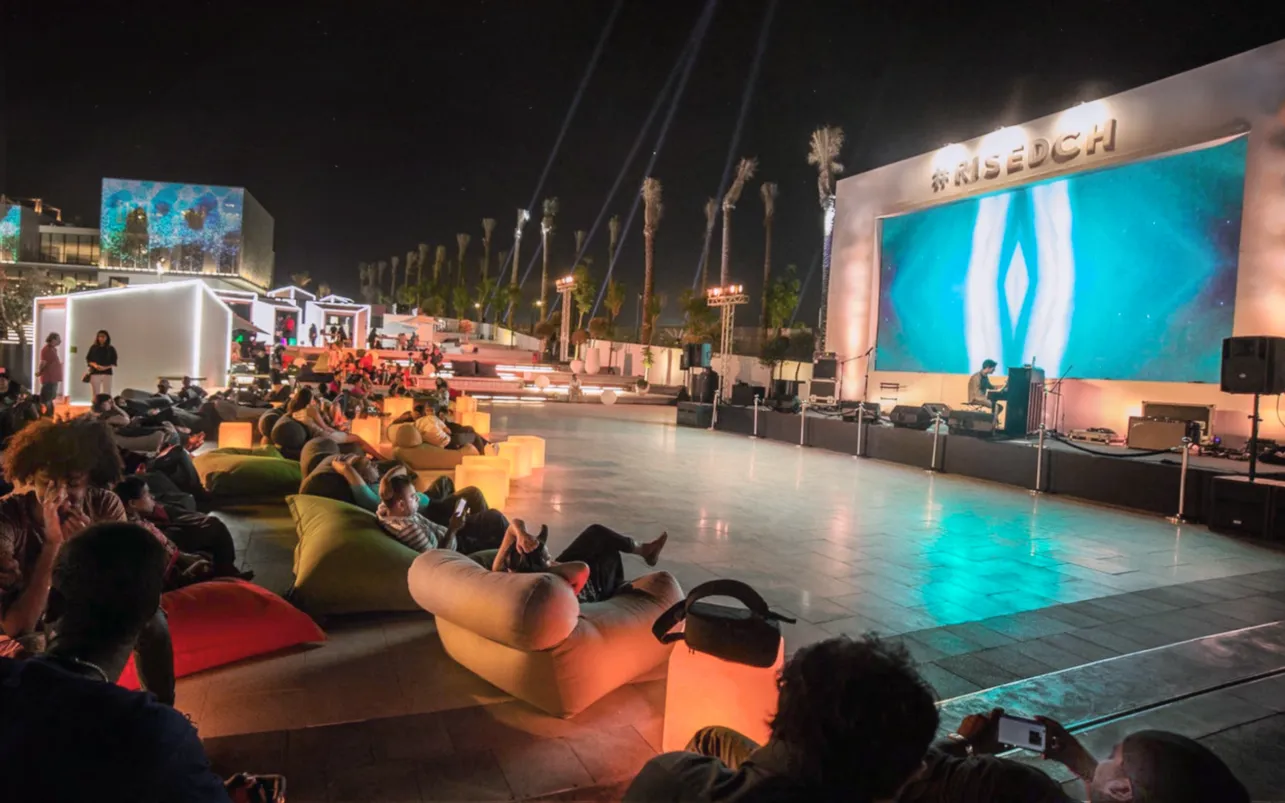 Audience reclines on lounge cushions during the open-air cinema