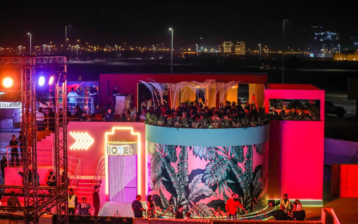 Cadillac Hotel activation glowing beside a waterfront concert at night