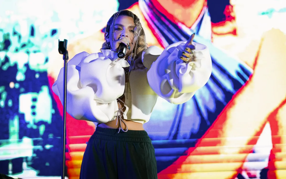 Female singer performs before a colorful LED stage screen