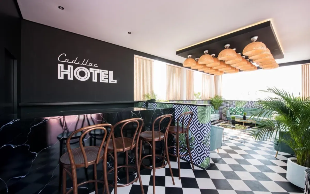 Cadillac Hotel lounge with patterned tiles, greenery, and sculptural ceiling