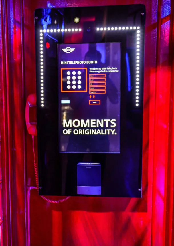 Interactive MINI photo booth framed by theatrical red curtains