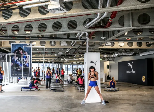Puma-branded fitness venue with rebounders arranged for a group class
