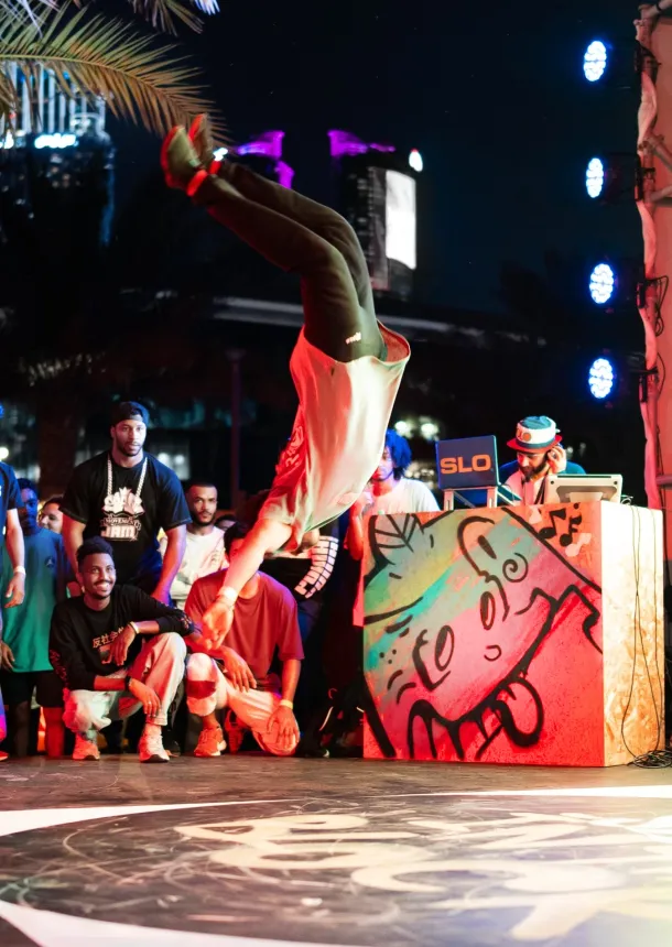 Breakdancer performs an inverted move during the outdoor festival