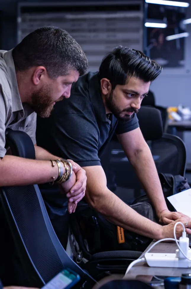 Two event managers review technical equipment during setup
