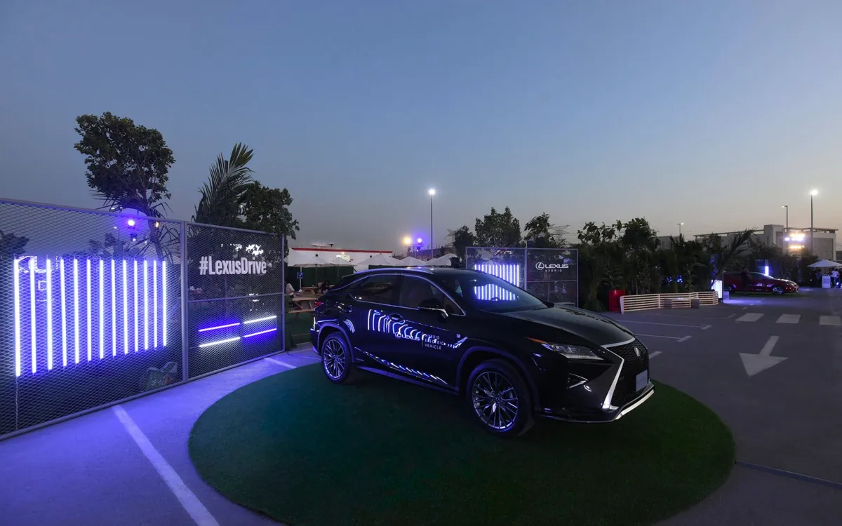 Lexus SUV displayed beside glowing entrance panels at the drive-in event