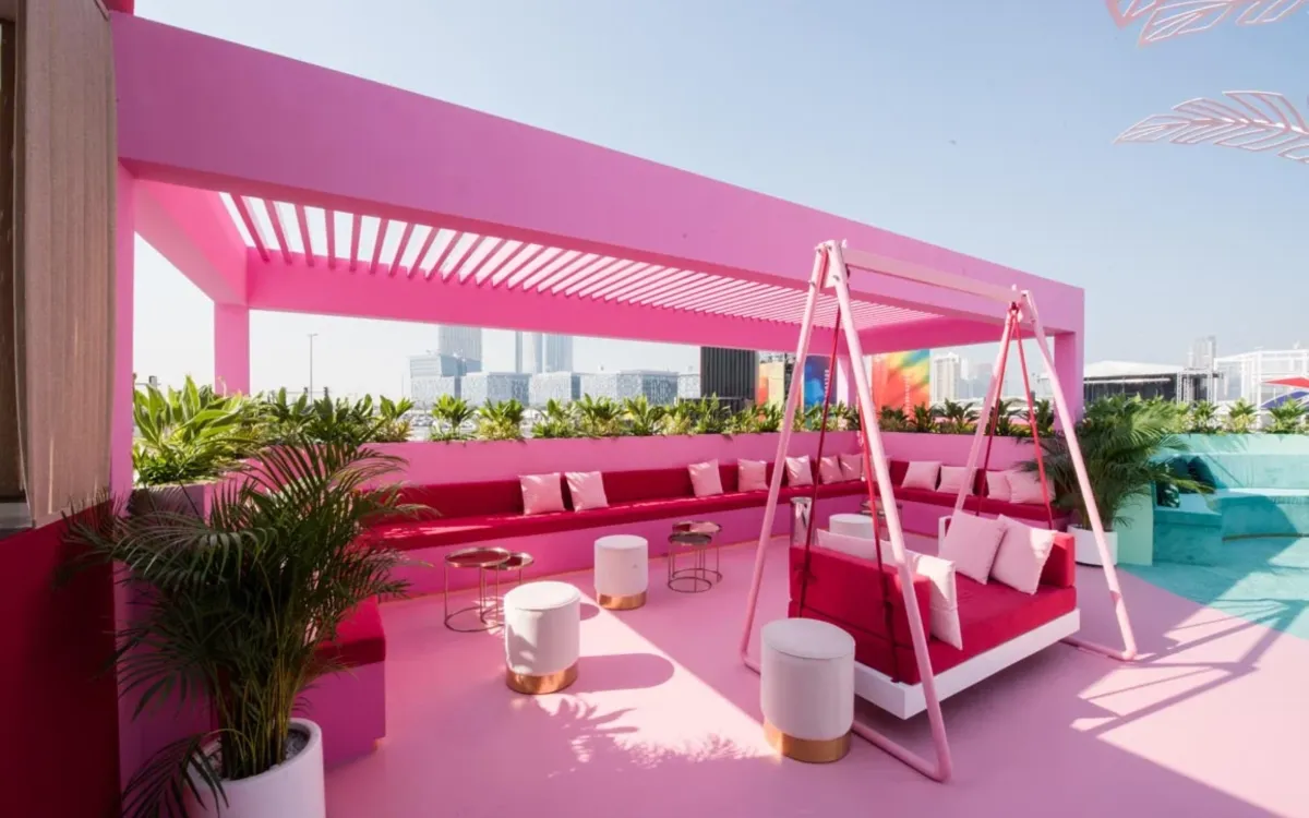 Pink Cadillac Hotel terrace with swing seating and pool views