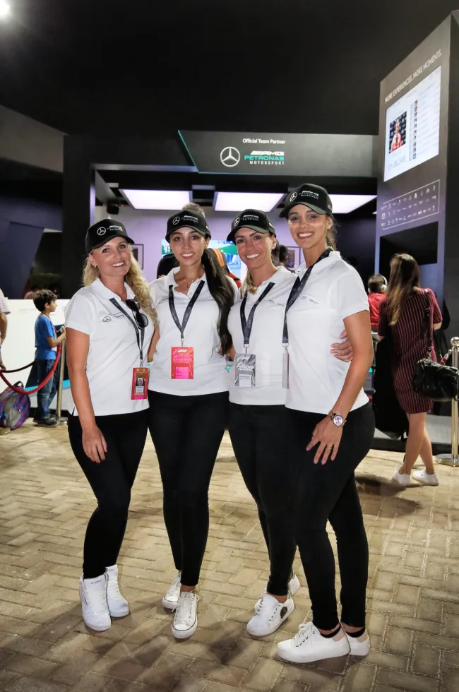 Four event hostesses pose in matching uniforms at the activation